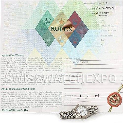 The image shows a Rolex Datejust 79174 Women's Stainless Steel White Dial 79174 Women's Stainless Steel White Dial watch positioned beside its official warranty and chronometer certification papers.
