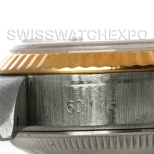 This image shows a close-up of the side of the Rolex Datejust 69173 Women's Stainless Steel Champagne Dial 69173 Women's Stainless Steel Champagne Dial's case, highlighting the model number 69173 and the gold fluted bezel.