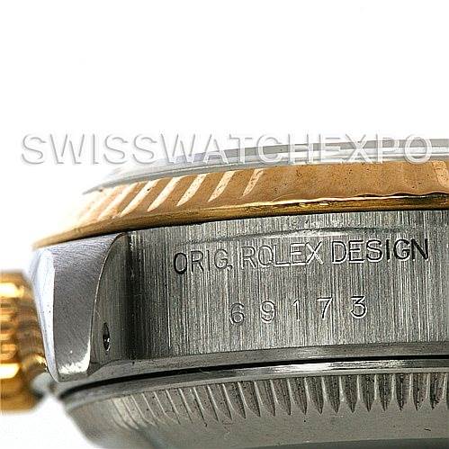 This close-up shows the side of the Rolex Datejust 69173 Women's Stainless Steel White Dial 69173 Women's Stainless Steel White Dial watch, highlighting the crown, bezel, and engraved model information.