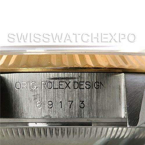 This image shows a close-up of the case side of a Rolex Datejust 69173 Women's Stainless Steel White Dial 69173 Women's Stainless Steel White Dial, displaying its model and serial number.