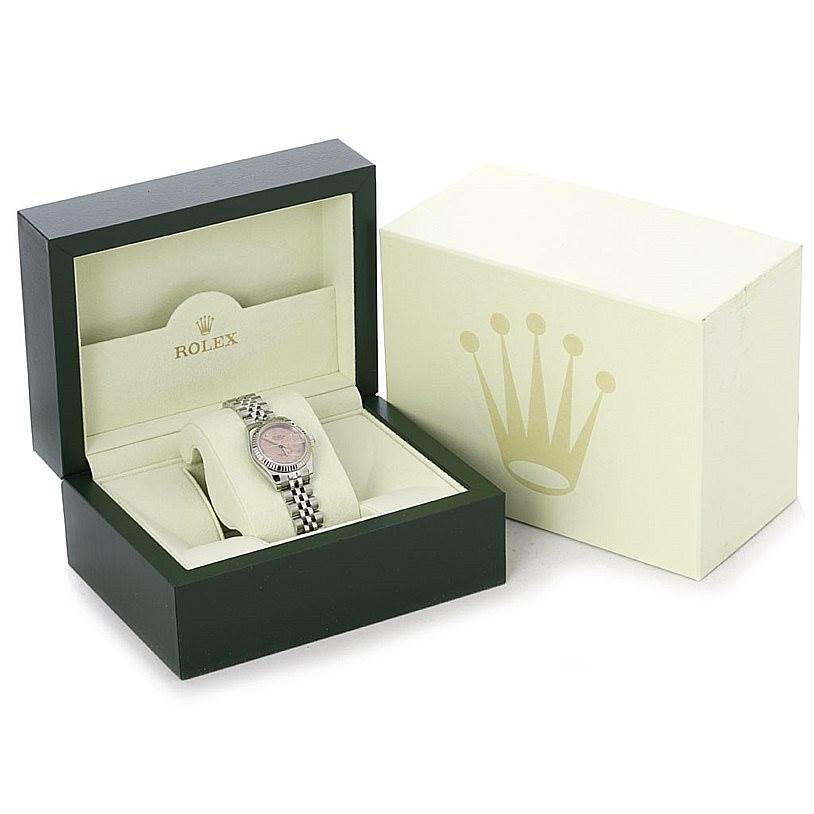 This image shows a Rolex Datejust 179174 Women's Stainless Steel Pink Dial 179174 Women's Stainless Steel Pink Dial watch placed inside its open green and cream display box, with an additional outer box beside it.