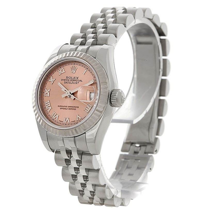 The Rolex Datejust 179174 Women's Stainless Steel Pink Dial 179174 Women's Stainless Steel Pink Dial watch is shown from a front-left angle, displaying the dial, bezel, crown, and part of the bracelet.
