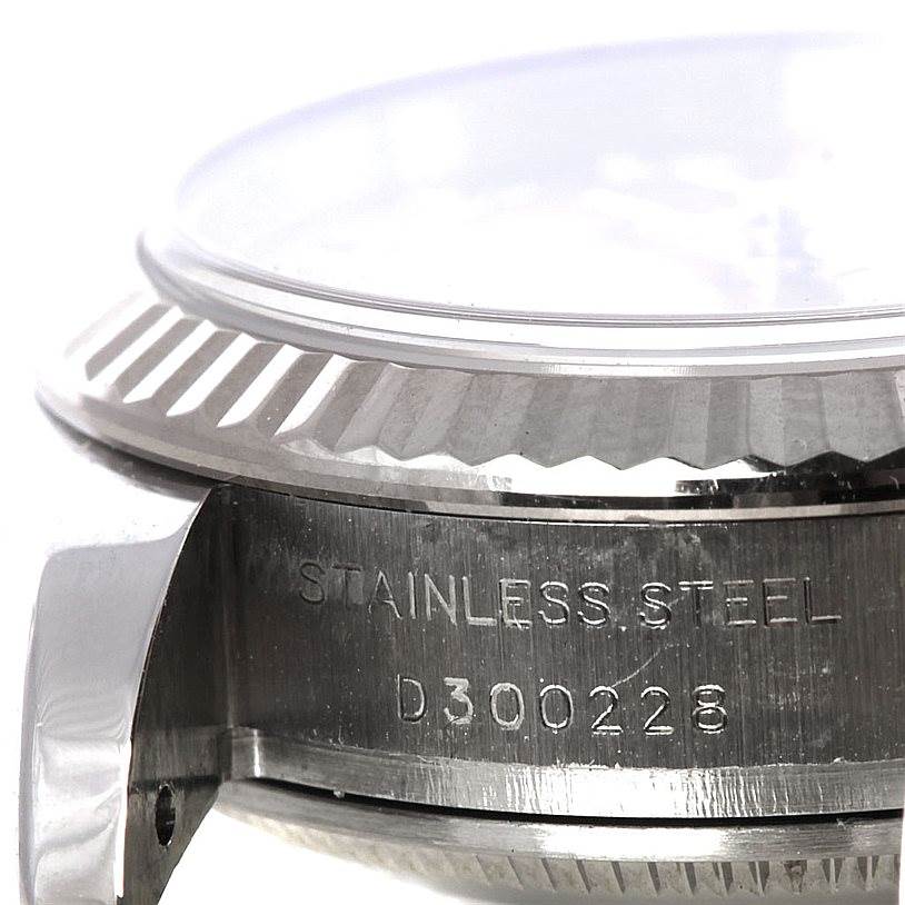 The image shows a close-up side view of the fluted bezel and case, including the serial number, of a Rolex Datejust 179174 Women's Stainless Steel Pink Dial 179174 Women's Stainless Steel Pink Dial watch.