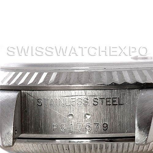 This image shows a close-up of the side of a Rolex Datejust 79174 Women's Stainless Steel Beige Dial 79174 Women's Stainless Steel Beige Dial watch case, highlighting the stainless steel and serial number.