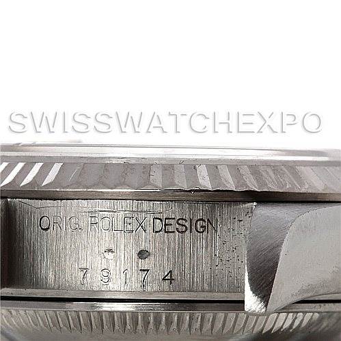 This image shows a close-up side view of the bezel and lugs of the Rolex Datejust 79174 Women's Stainless Steel Beige Dial 79174 Women's Stainless Steel Beige Dial watch, highlighting the engraved model number.