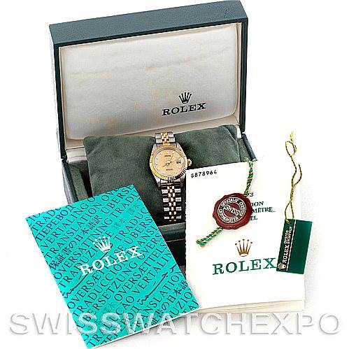 The image shows a Rolex Datejust 69173 Women's Stainless Steel Champagne Dial 69173 Women's Stainless Steel Champagne Dial watch in its box, along with manuals, a tag, and a certificate.