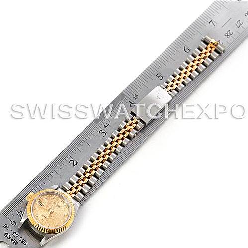 A Rolex Datejust 69173 Women's Stainless Steel Champagne Dial 69173 Women's Stainless Steel Champagne Dial watch is shown horizontally alongside a ruler, displaying its bracelet and case.