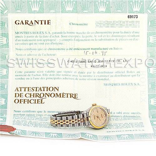 The image shows the side view of a Rolex Datejust 69173 Women's Stainless Steel Champagne Dial 69173 Women's Stainless Steel Champagne Dial watch, featuring its bracelet and case, placed on a warranty certificate.