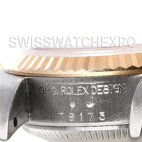 The image shows a close-up of the side of a Rolex Datejust 79173 Women's Stainless Steel Champagne Dial 79173 Women's Stainless Steel Champagne Dial watch case, highlighting the fluted bezel and engraved serial number.