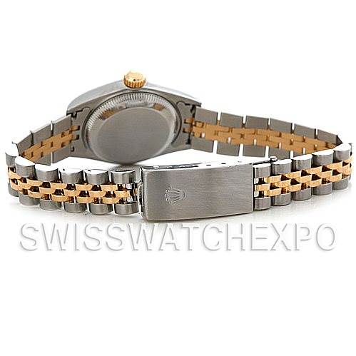 The image shows the back view of a Rolex Datejust 79173 Women's Stainless Steel Champagne Dial 79173 Women's Stainless Steel Champagne Dial watch, highlighting the case back, gold crown, and two-tone bracelet with a clasp.