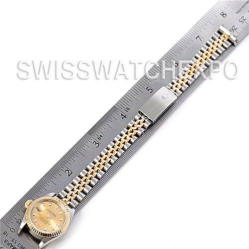 The Rolex Datejust 79173 Women's Stainless Steel Champagne Dial 79173 Women's Stainless Steel Champagne Dial watch is displayed flat, showing the full face, bracelet, and clasp alongside a measurement ruler.