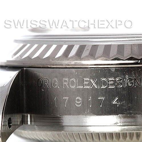This image shows a close-up side view of the case and bezel with engraved text of a Rolex Datejust 179174 Women's Stainless Steel Silver Dial 179174 Women's Stainless Steel Silver Dial watch.