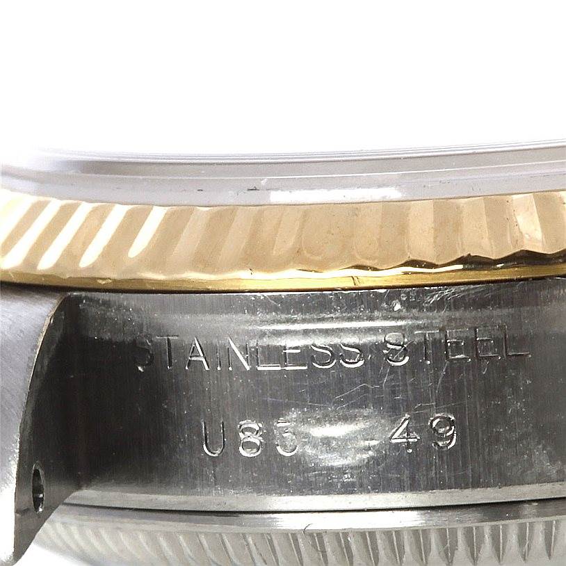 This image of the Rolex Datejust 69173 Women's Stainless Steel White Dial 69173 Women's Stainless Steel White Dial watch shows a close-up of the side case, stainless steel, and fluted gold bezel.