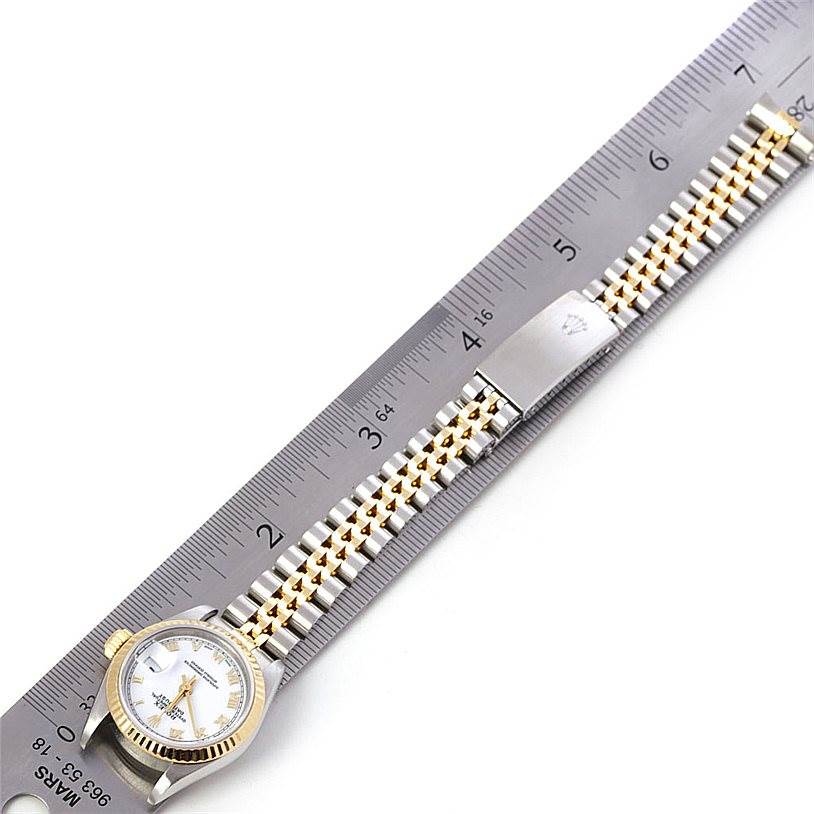 The image shows a Rolex Datejust 69173 Women's Stainless Steel White Dial 69173 Women's Stainless Steel White Dial watch laid flat against a ruler, highlighting the face and full bracelet.