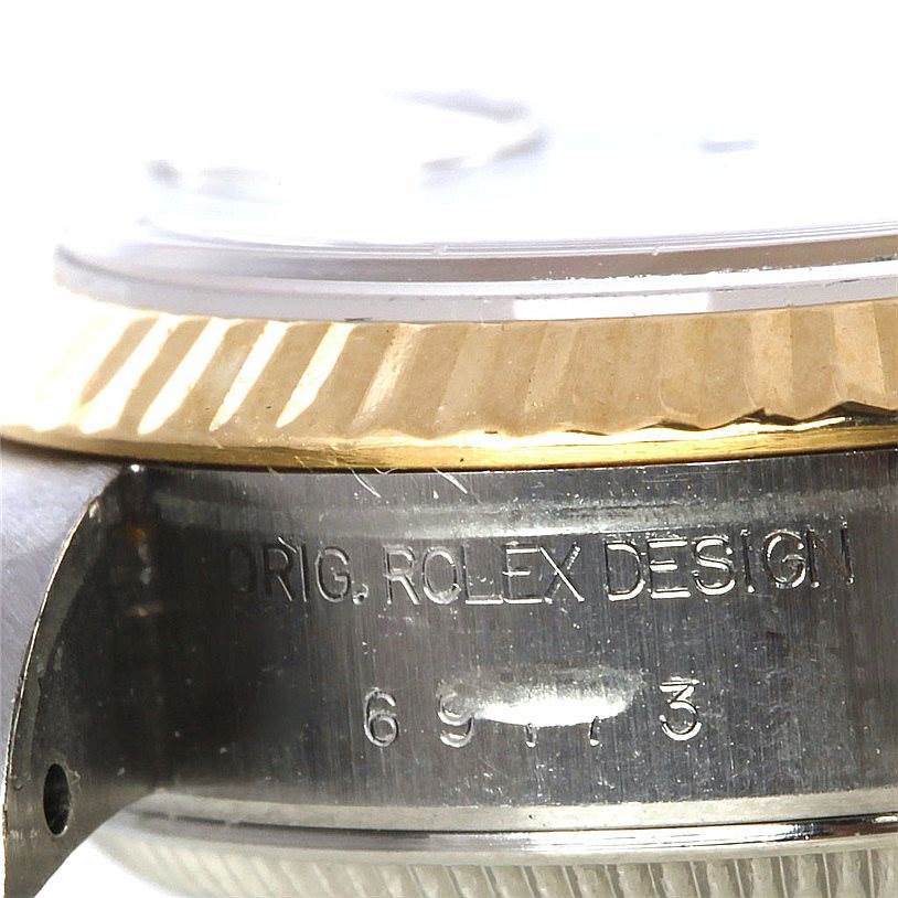 The image shows a close-up angle of the bezel and case side of a Rolex Datejust 69173 Women's Stainless Steel White Dial 69173 Women's Stainless Steel White Dial watch, highlighting the engraved text.