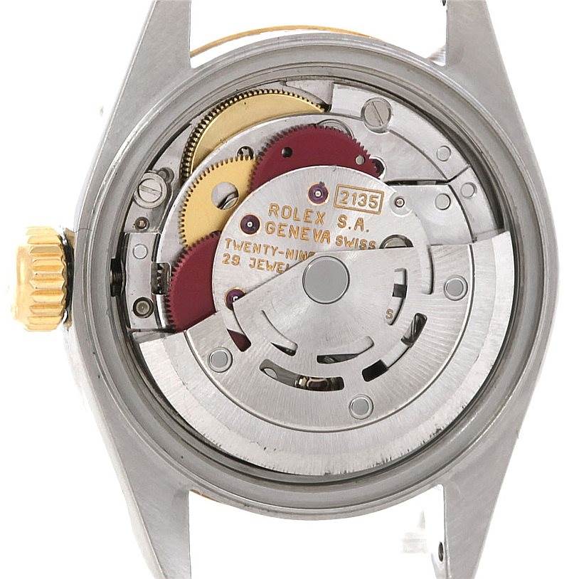 This is a close-up view of the back of a Rolex Datejust 69173 Women's Stainless Steel White Dial 69173 Women's Stainless Steel White Dial watch, showcasing its internal mechanical movement and rotor.
