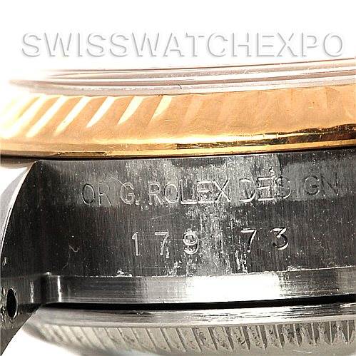 The image shows a close-up of the side of a Rolex Datejust 179173 Women's Steel and Gold (two tone) Champagne Dial 179173 Women's Steel and Gold (two tone) Champagne Dial watch, highlighting the model number and "ORIG ROLEX DESIGN" engraving.