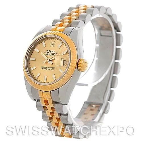 The image shows a Rolex Datejust 179173 Women's Steel and Gold (two tone) Champagne Dial 179173 Women's Steel and Gold (two tone) Champagne Dial watch from a front-left angle, highlighting its two-tone bracelet and gold bezel.