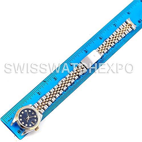 The image shows a Rolex Datejust 79173 Women's Stainless Steel Blue Dial 79173 Women's Stainless Steel Blue Dial watch laid flat against a blue ruler, displaying its face and bracelet.