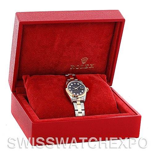 The Rolex Datejust 79163 Women's Steel and Gold (two tone) Black Dial 79163 Women's Steel and Gold (two tone) Black Dial watch is displayed front-on inside an open, red box with a red cushion.