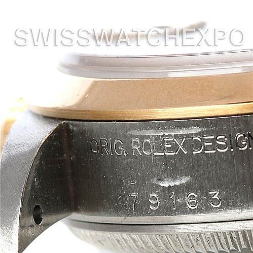 This image shows a close-up of the side of a Rolex Datejust 79163 Women's Steel and Gold (two tone) Black Dial 79163 Women's Steel and Gold (two tone) Black Dial watch, featuring the case and model number engraving "79163".