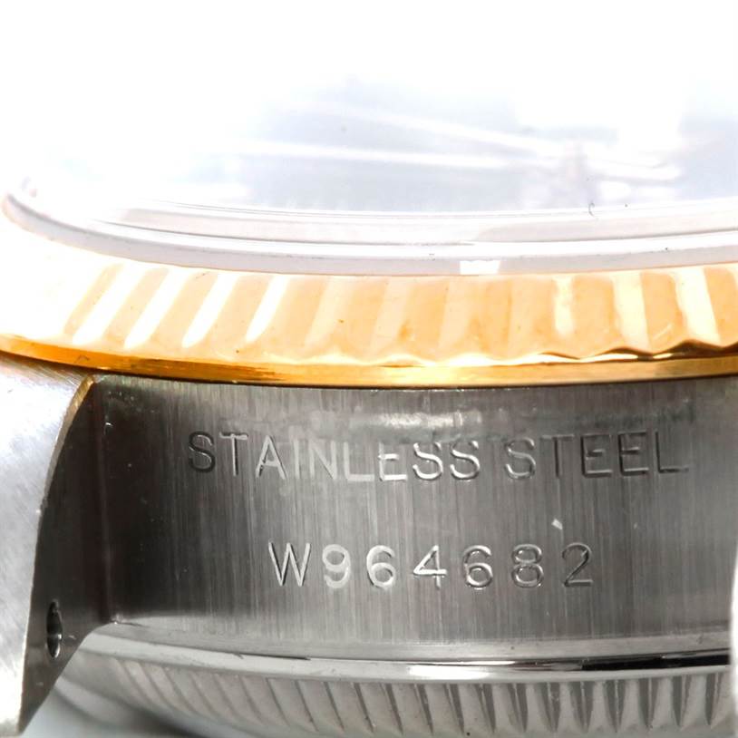 The image shows a close-up of the side of a Rolex Datejust 69173 Women's Stainless Steel Black Dial 69173 Women's Stainless Steel Black Dial watch case, featuring the serial number and part of the bezel.