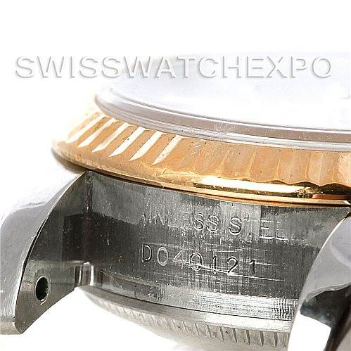 This image showcases a close-up of the side case and bezel of the Rolex Datejust 179173SSJ Women's Steel and Gold (two tone) Champagne Dial 179173SSJ Women's Steel and Gold (two tone) Champagne Dial, highlighting the serial number engraving.