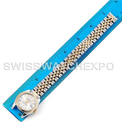 The image shows a Rolex Datejust 179173SSJ Women's Steel and Gold (two tone) Champagne Dial 179173SSJ Women's Steel and Gold (two tone) Champagne Dial watch lying flat next to a ruler, displaying its face, bezel, and bracelet.