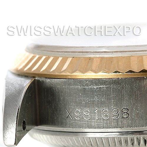 The image shows a close-up of the side of a Rolex Datejust 69173 Women's Stainless Steel White Dial 69173 Women's Stainless Steel White Dial model, focusing on the serial number engraved between the lugs and part of the bezel.