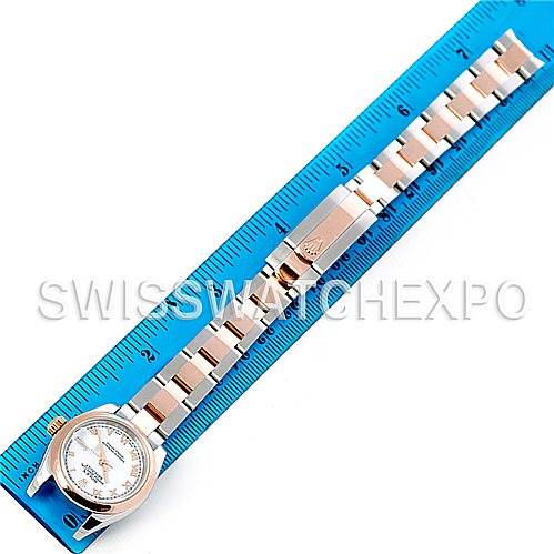 The image shows the Rolex Datejust 179161 Women
s Steel and Gold (two tone) White Dial 179161 Women
s Steel and Gold (two tone) White Dial watch laid flat with its strap fully extended next to a blue ruler for measurement.