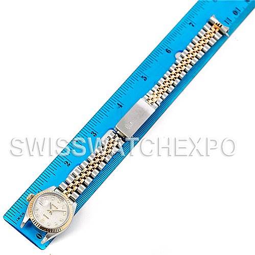 The Rolex Datejust 79173 Women's Stainless Steel Silver Dial 79173 Women's Stainless Steel Silver Dial watch is shown from a top view, featuring both the dial and full bracelet on a ruler.