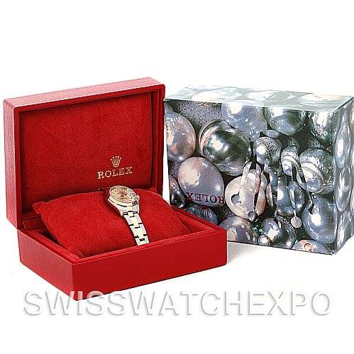 This image shows a Rolex Datejust 79163 Women's Steel and Gold (two tone) Silver Dial 79163 Women's Steel and Gold (two tone) Silver Dial watch displayed in an open red velvet box alongside its decorative outer box.