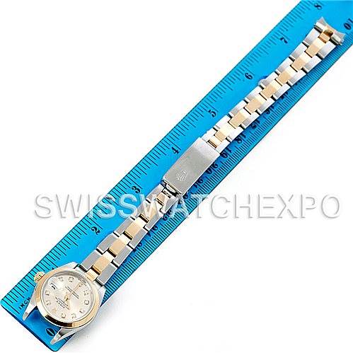 The Rolex Datejust 79163 Women's Steel and Gold (two tone) Silver Dial 79163 Women's Steel and Gold (two tone) Silver Dial watch is shown laid flat next to a blue ruler, displaying the face, bracelet, and clasp.