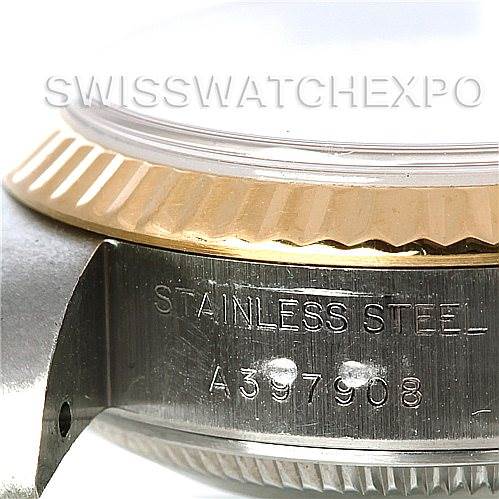 This image shows a close-up of the side view of a Rolex Datejust 79173 Women's Stainless Steel Mother of Pearl Dial 79173 Women's Stainless Steel Mother of Pearl Dial, highlighting the fluted bezel and part of the case with the serial number.