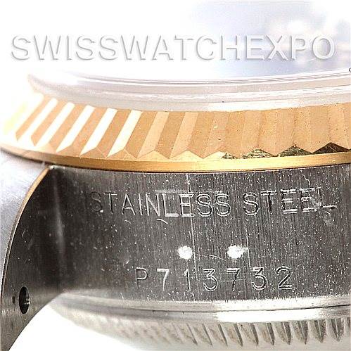 The image shows a close-up of the Rolex Datejust 79173 Women's Stainless Steel Blue Dial 79173 Women's Stainless Steel Blue Dial model's side bezel and case, highlighting the stainless steel and serial number.