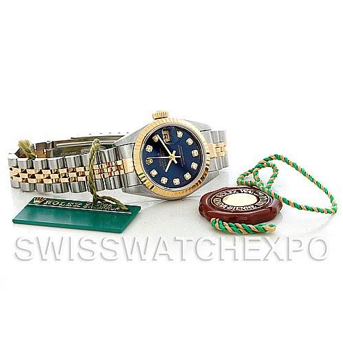 This image shows a Rolex Datejust 79173 Women's Stainless Steel Blue Dial 79173 Women's Stainless Steel Blue Dial watch from a slightly elevated angle, along with its tags and accessories.