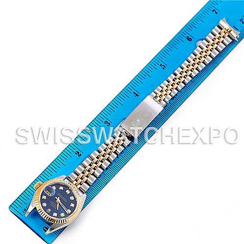 The image shows a top-view angle of a Rolex Datejust 79173 Women's Stainless Steel Blue Dial 79173 Women's Stainless Steel Blue Dial watch with a blue dial and an entire-length view of its bracelet next to a ruler.