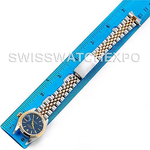 The Rolex Datejust 69173 Women's Stainless Steel Blue Dial 69173 Women's Stainless Steel Blue Dial watch is shown from a top-down view, displaying the face, bezel, and bracelet placed alongside a ruler.