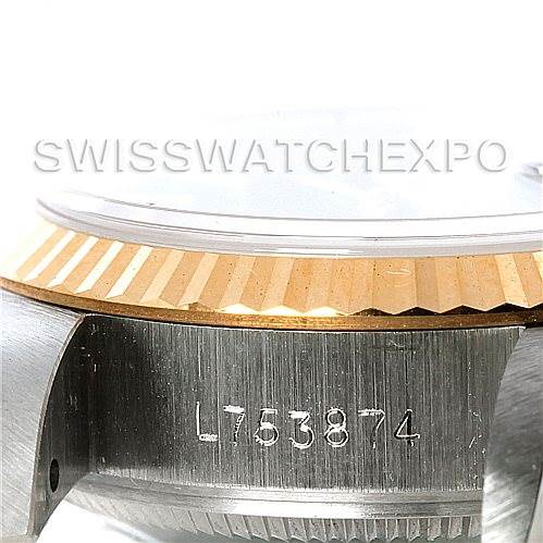 This image shows a close-up of the side view of the Rolex Datejust 69173 Women's Stainless Steel Blue Dial 69173 Women's Stainless Steel Blue Dial watch, highlighting the bezel, case, and serial number.