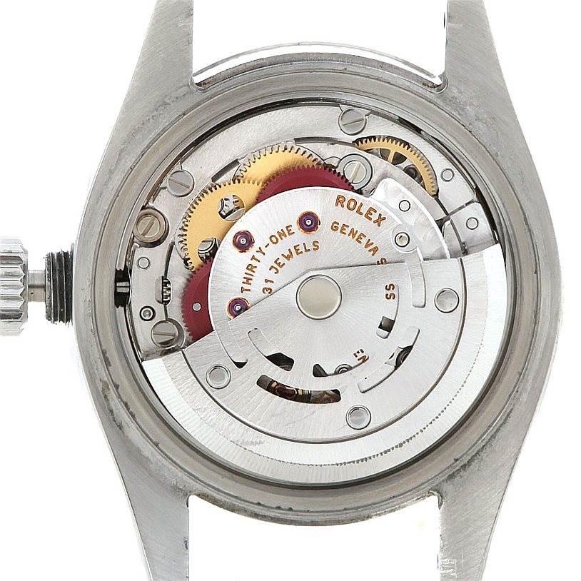 This image shows the internal mechanism of a Rolex Datejust 179174 Women's Stainless Steel Blue Dial 179174 Women's Stainless Steel Blue Dial watch from a back angle, highlighting gears and the rotor.