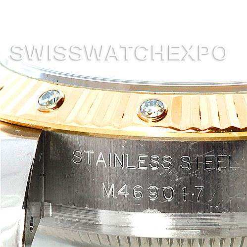 The image shows the side of the Rolex Datejust 179313 Women's Stainless Steel Mother of Pearl Dial 179313 Women's Stainless Steel Mother of Pearl Dial watch, highlighting the stainless steel part with an engraved serial number and the gold bezel with gemstones.