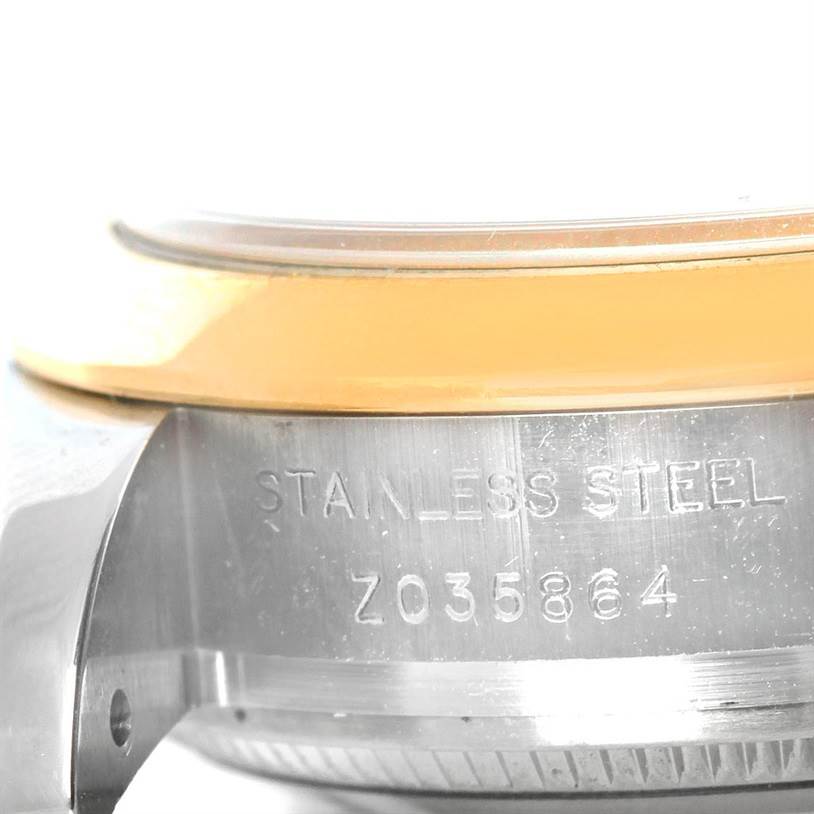 The image shows a close-up view of the case side and bezel of a Rolex Datejust 179163 Women's Steel and Gold (two tone) White Dial 179163 Women's Steel and Gold (two tone) White Dial watch, highlighting the stainless steel material and serial number.