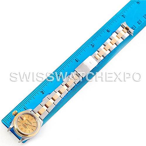 The image shows a Rolex Datejust 69163 Women
s Stainless Steel Champagne Dial 69163 Women
s Stainless Steel Champagne Dial watch laid flat next to a ruler, displaying the face, bracelet, and clasp of the watch.