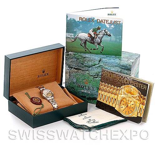The image shows a Rolex Datejust 69163 Women
s Stainless Steel Champagne Dial 69163 Women
s Stainless Steel Champagne Dial watch with its box, booklets, and accessories, including a cleaning cloth and tag.
