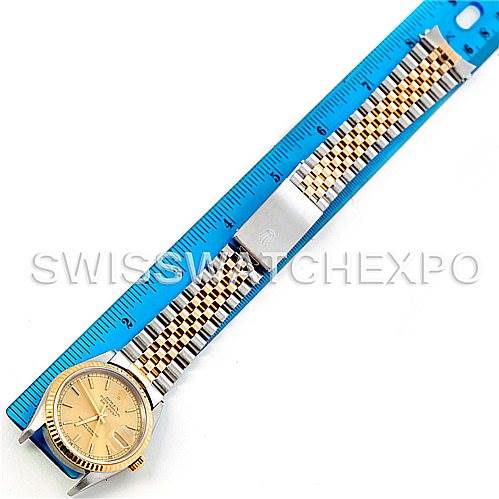 The image shows a top-down view of a Rolex Datejust 16233 Men's Steel and Gold (two tone) Champagne Dial 16233 Men's Steel and Gold (two tone) Champagne Dial watch, including its face, bezel, and two-tone bracelet next to a ruler.