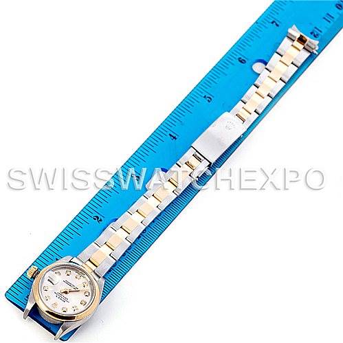 The image shows a Rolex Datejust 79163 Women's Steel and Gold (two tone) Silver Dial 79163 Women's Steel and Gold (two tone) Silver Dial model watch laid out flat next to a blue ruler, displaying its dial, bracelet, and clasp.