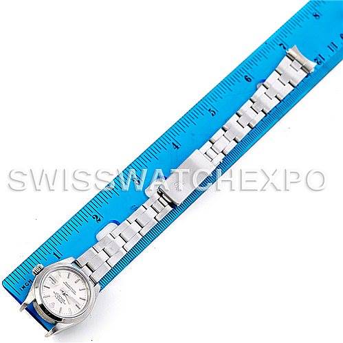 The image shows a top-down view of a Rolex Datejust 79160 Women
s Stainless Steel Silver Dial 79160 Women
s Stainless Steel Silver Dial watch next to a blue ruler for scale.