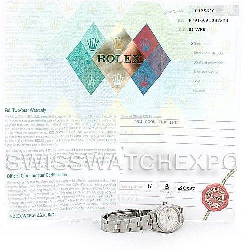 The image shows a Rolex Datejust 79160 Women
s Stainless Steel Silver Dial 79160 Women
s Stainless Steel Silver Dial watch lying flat with its certification papers and warranty card in the background.