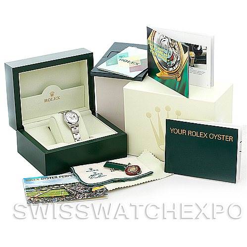 The image displays a Rolex Datejust 79160 Women
s Stainless Steel Silver Dial 79160 Women
s Stainless Steel Silver Dial watch in its box, accompanied by manuals, a cleaning cloth, a tag, and additional packaging.