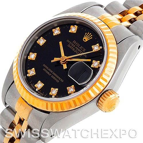 The image shows a close-up of the Rolex Datejust 69173 Women's Stainless Steel Black Dial 69173 Women's Stainless Steel Black Dial watch, highlighting its black dial, gold fluted bezel, diamond hour markers, and crown.